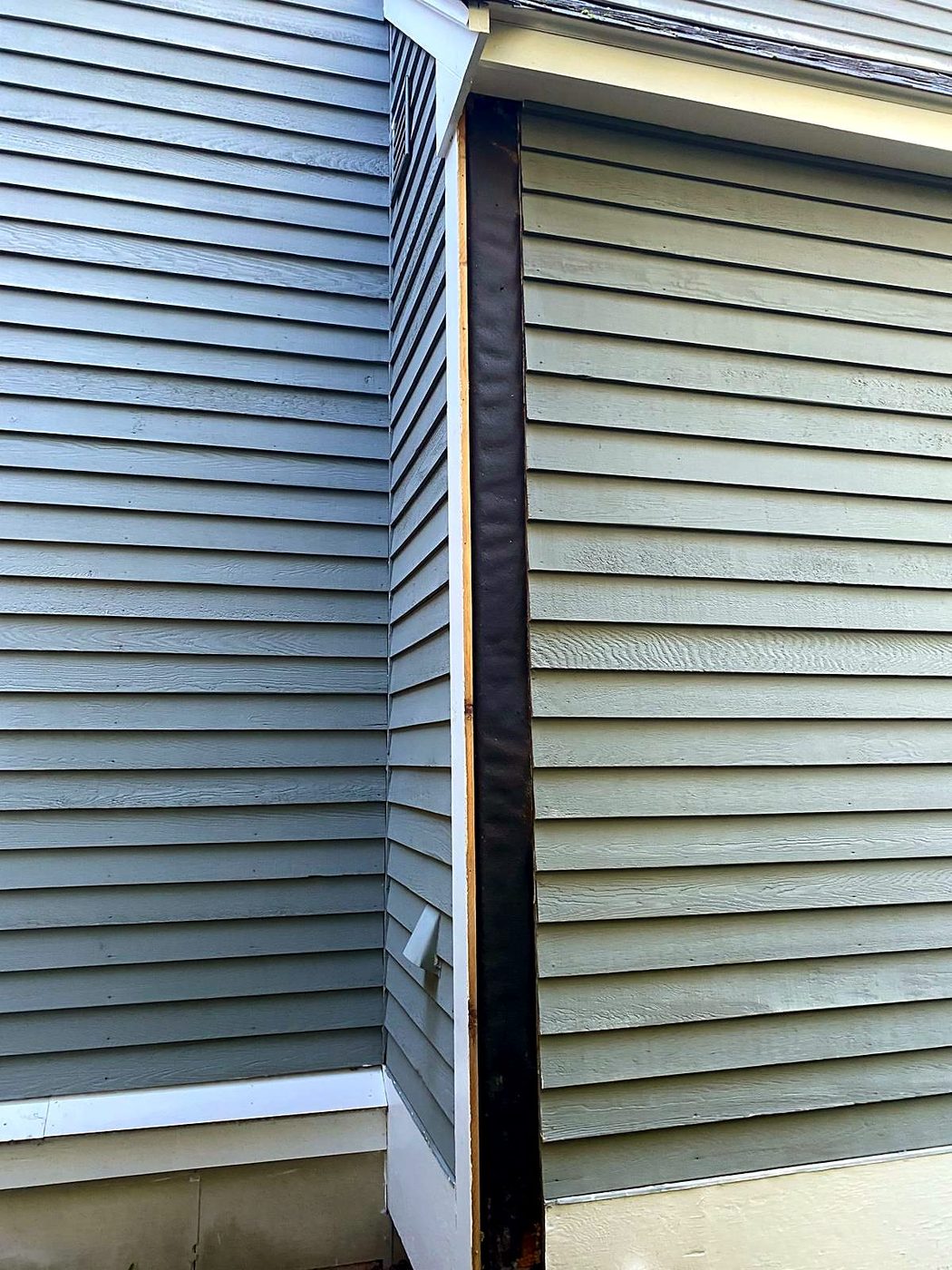 Corner board removed down to the membrane on lap siding at a Concord, MA condominium