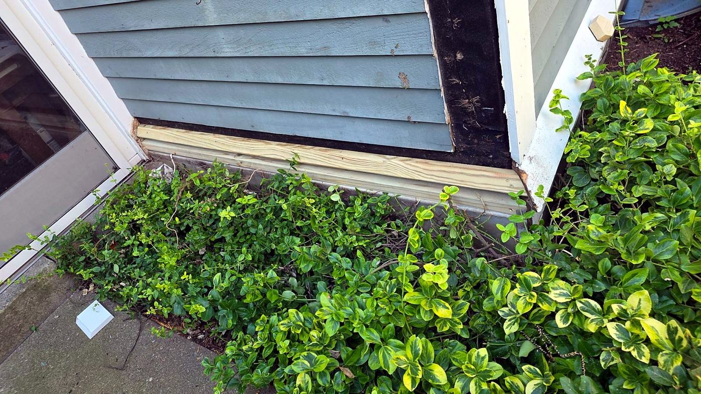 New trim board installed at the base of the wall during exterior repair at a Concord, MA condominium
