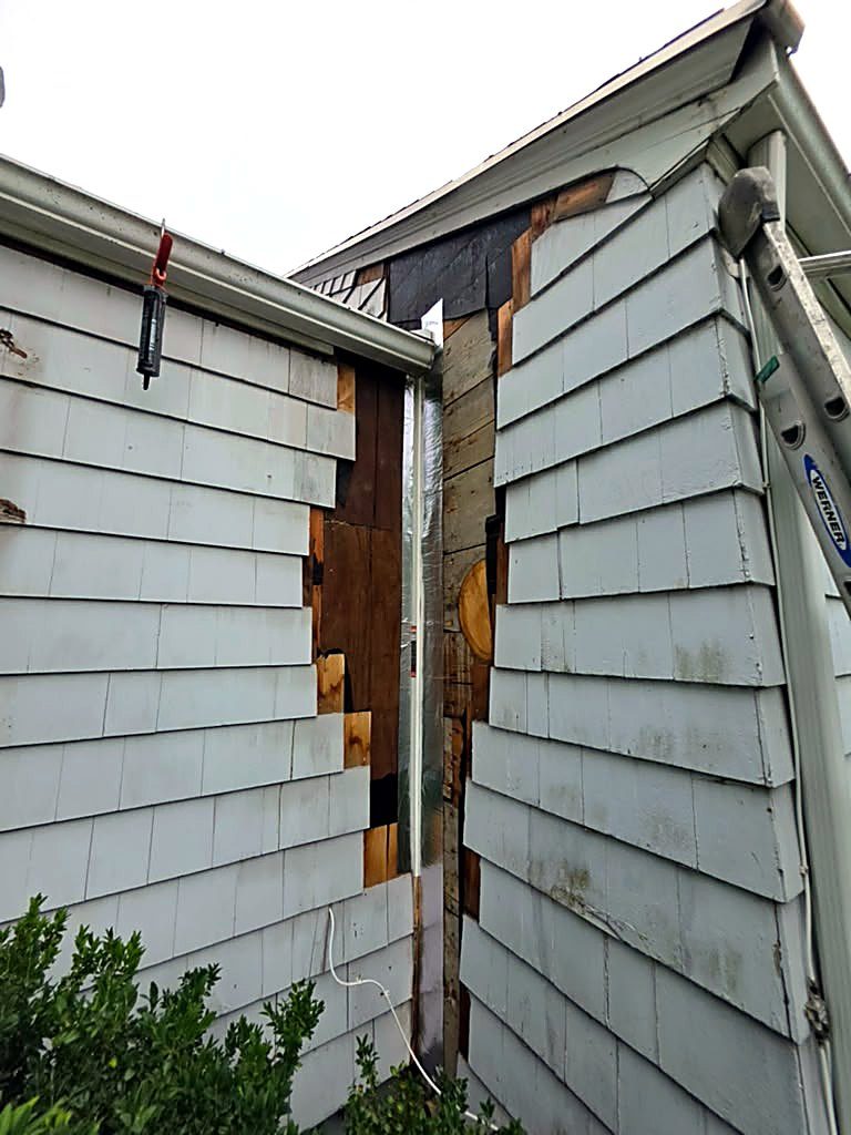 Rotted wood cut out at the inside corner of a Worcester, MA cape during structural rot repair