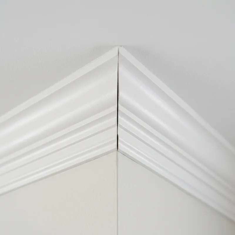 Design idea: close-up of a coped inside corner of painted crown molding